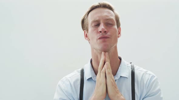 Guy with Fair Hair and Blue Eyes Runs Fingers on Face