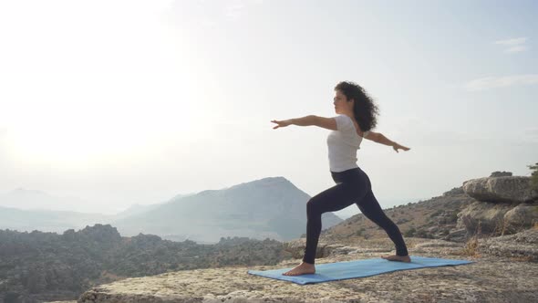 Unrecognizable woman practicing balancing yoga asana in nature