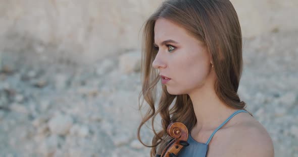 Smiling Woman Coming at Serious Female Violinists Who Looks Thoughtfully