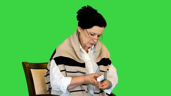 Senior Woman Having Arterial Pressure on a Green Screen Chroma Key