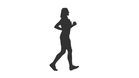 Silhouette of Young Woman Jogging in Shorts