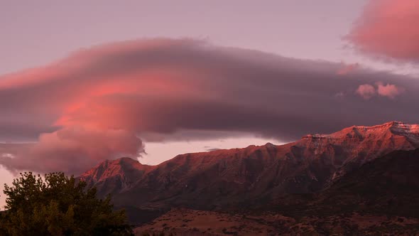 Lenticular clouds during colorful sunset over Timpanogos Mountain