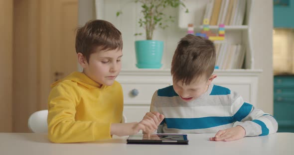 Two Boys with Autism Using One Tablet Computer for Education Application