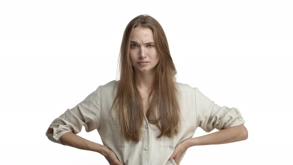 Video of Pretty Blond Caucasian Woman with Teeth Braces Looking Suspicious and Doubtful Raising