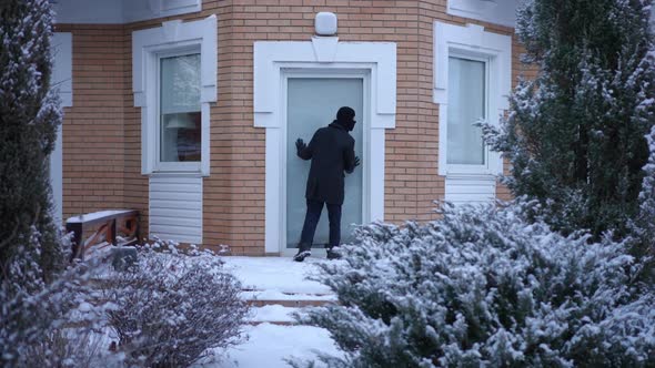 Wide Shot Noticed Burglar Escaping on Snowy Backyard Outdoors Running Away