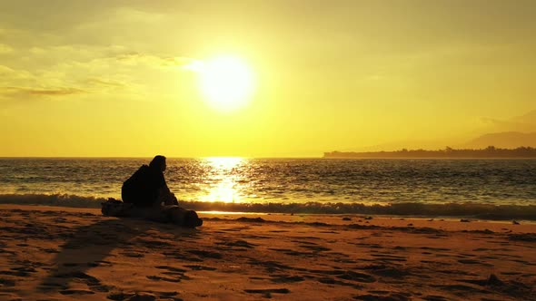 Lady tans on idyllic shore beach vacation by blue sea with white sandy background of the Maldives in