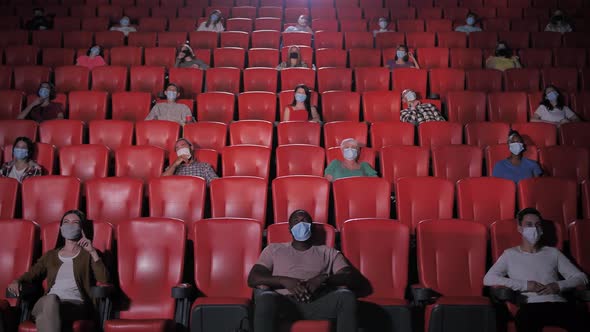 Multinational People in Masks Laughing at Cinema