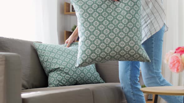 Woman Arranging Cushions at Home