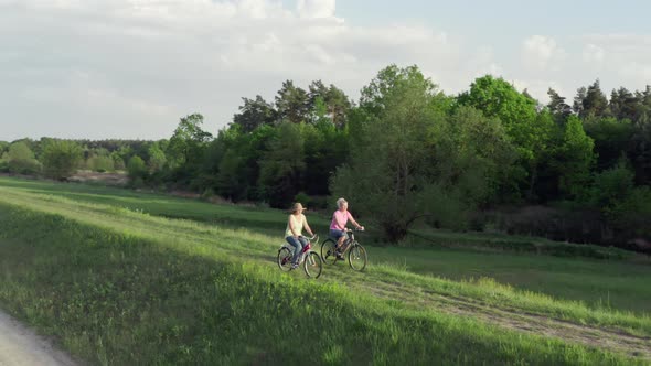 Beautiful Nature at Sunset and Women Riding Bicycles