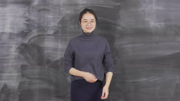 Portrait of Asian Beautiful Girl against Chalkboard