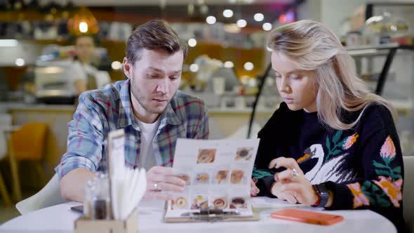 Cheerful Man and Woman Having Coffee Together