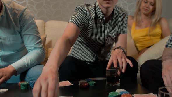 Close Up of People's Hands with Playing Cards and Chips at Home