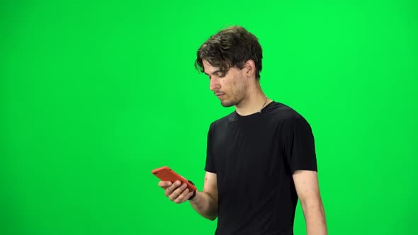 Brunette Guy Goes and Texting on the Phone, Chroma Key. Slow Motion