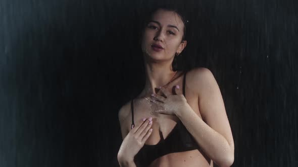 Attractive Young Woman with Hot Slim Body Walks Towards the Camera Under the Rain