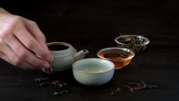 Pouring Chinese Traditional Tea Ceremony on Grey Background