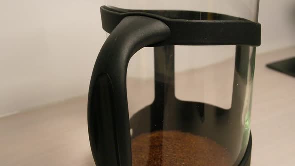 Close up of making instant coffee by adding granules and heated water.