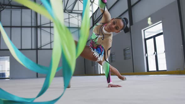 Female gymnast performing at sports hall