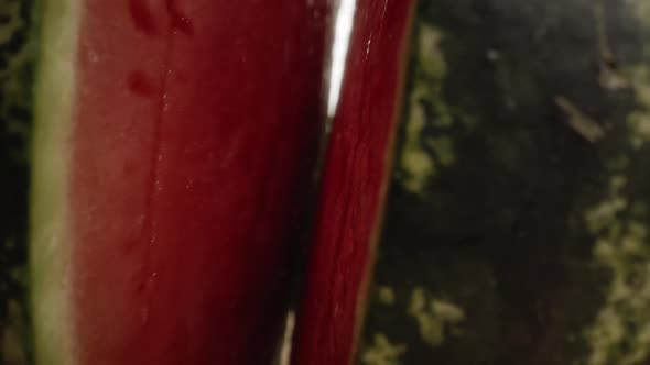 Zoom in macro video of  watermelon opening into halves. Shot with RED helium camera in 8K