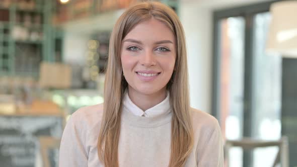 Portrait of Young Woman Smiling at the Camera 