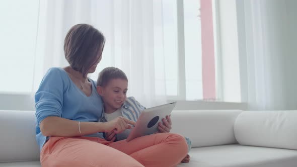 Mother and Son Playing with Digital Tablet at Home