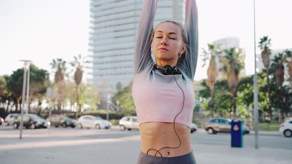 Sporty Millennial Female Stretch Muscles Before Running on City Street