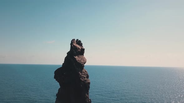 Aerial View on High Rock in Mediterranean Sea Against Horizon. Blue Sky. Flying Birds. Lipari