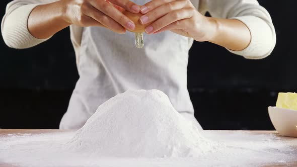Woman adding egg white into flour 4k