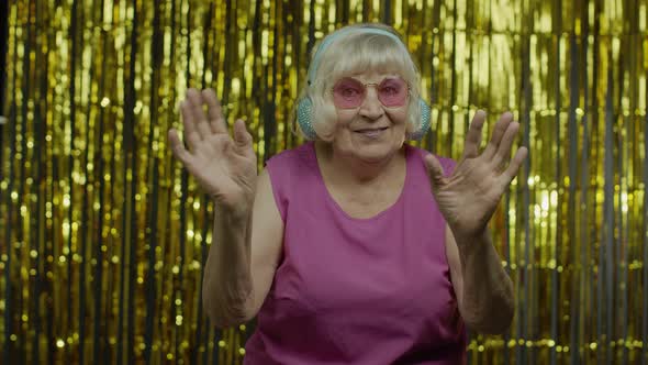 Friendly Senior Old Woman Waving Hands Looking at Camera with Toothy Smile, Saying Hi, Greeting