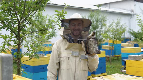 A Beekeeper with Old Bee Smoker on the Apiary