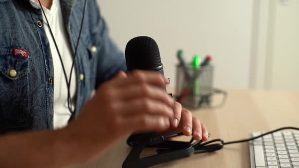 Closeup Hands of Unrecognizable Male Audio Blogger Testing Microphone Working By Tapping It with