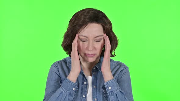 Old Woman Having Headache on Green Chroma Key Background