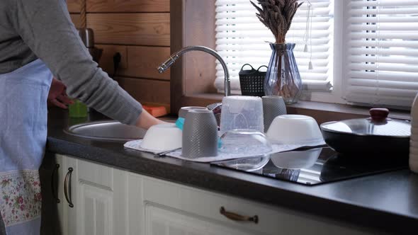 Housewife Doing Cleaning and Drying Dishes