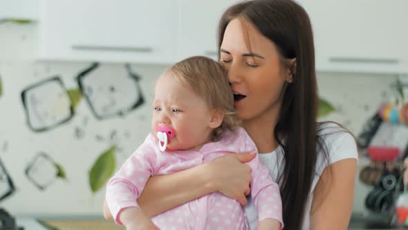 Mother Comforting Her Crying Little Daughter  Parenthood Concept