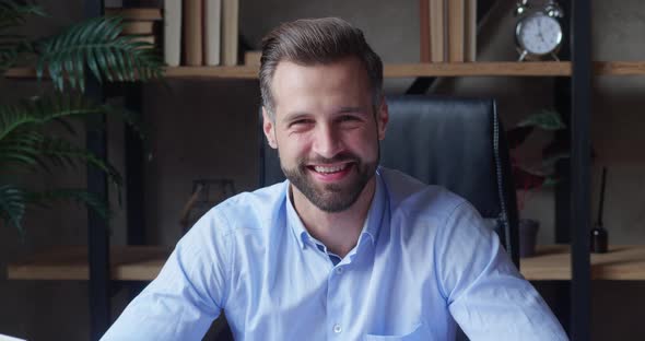 Smiling Bearded Leader Looking at Camera