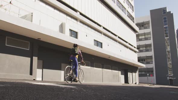 Mixed race woman riding bike on the street