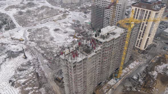 Residential area is being built by lifting cranes and other machines