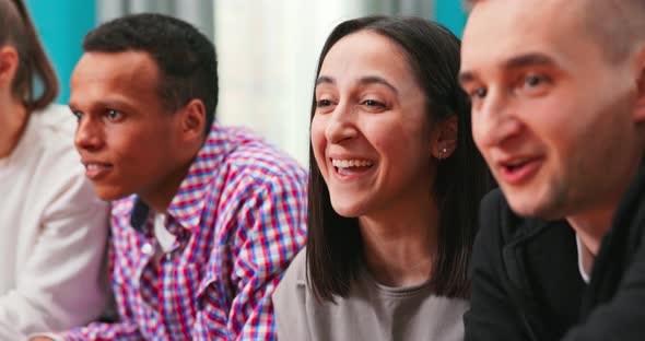 Close Up of Multinational Group of College Students Sit on the Couch and Play Video