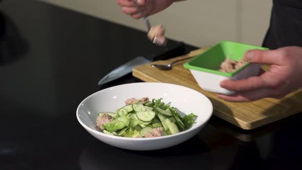 Fresh organic salad with tuna in white bowl