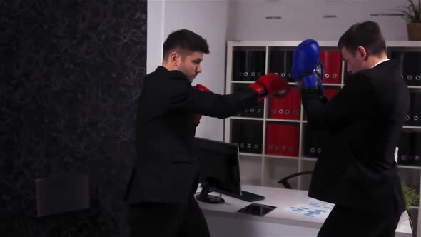Two Businessmen Boss and His Empoyee Boxing in Office Room