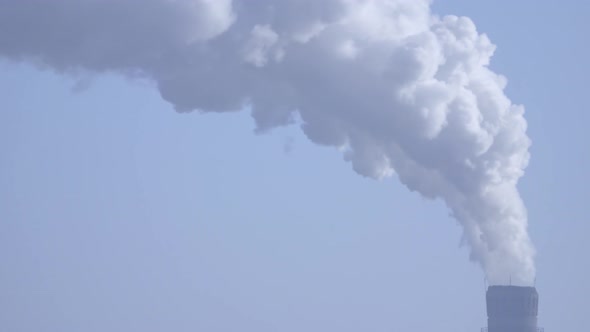 Smoke Stack with a Nice Smoke Over Blue Sky