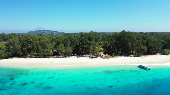 Daytime flying tourism shot of a summer white paradise sand beach and blue water background in best 