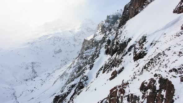 Motion Past Mountain with Shiny Snow and Bare Plots in Fog