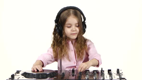Little Girl in Headphones Plays for Dj Console, White Background alt