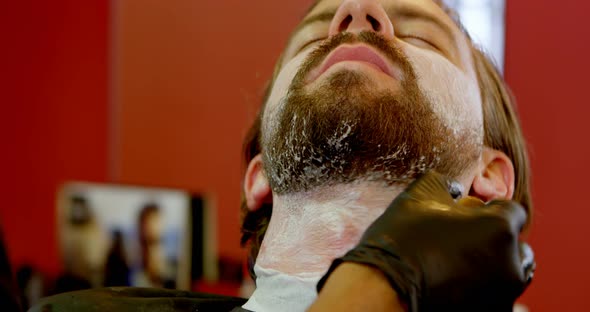 Barber Applying Shaving Cream on Mans Beard 4k