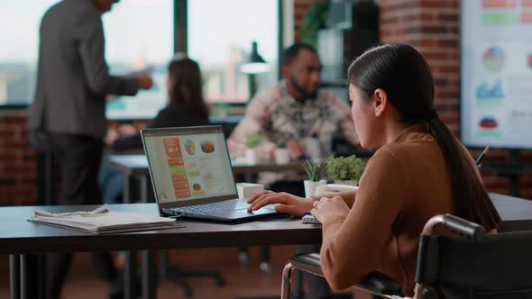 Office Worker Using Laptop to Work on Economy Development