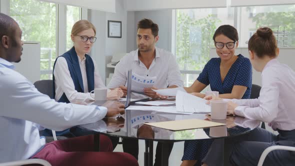 Indian Businessman Executive in Group Meeting Discussion with Employees in Modern Office