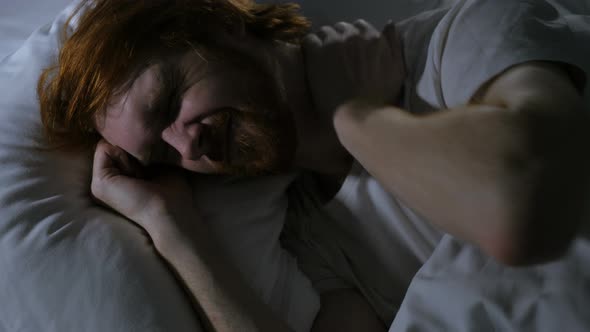 Man with Neck Pain Trying to Sleep in Bed at Night