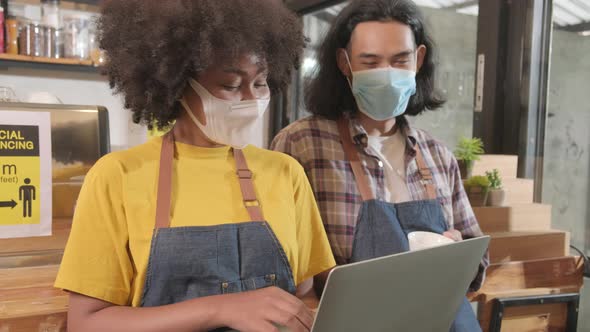 Two barista partners wait for customers order in new normal lifestyle service.