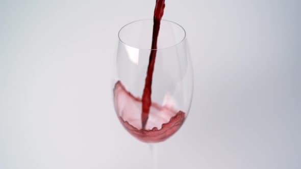 Pouring red wine into glass, Slow Motion