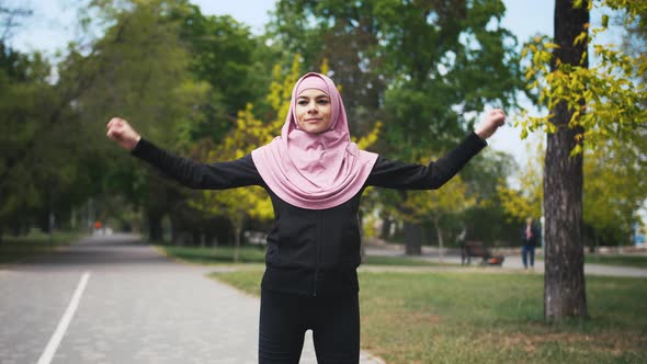Young Fitness Muslim Woman Doing Sport Excercises Before Run in Park